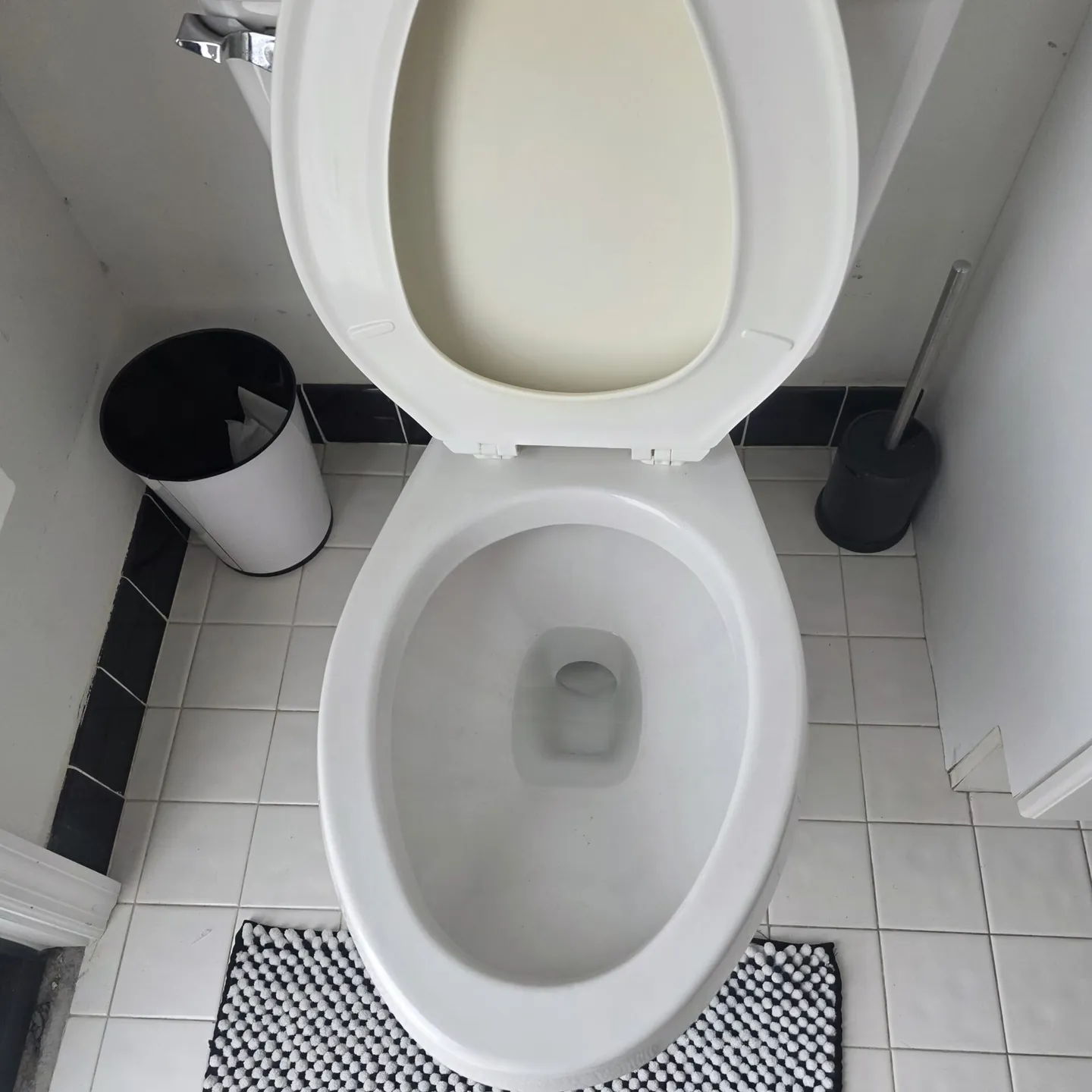 The same toilet after cleaning, a white bowl and clean floor